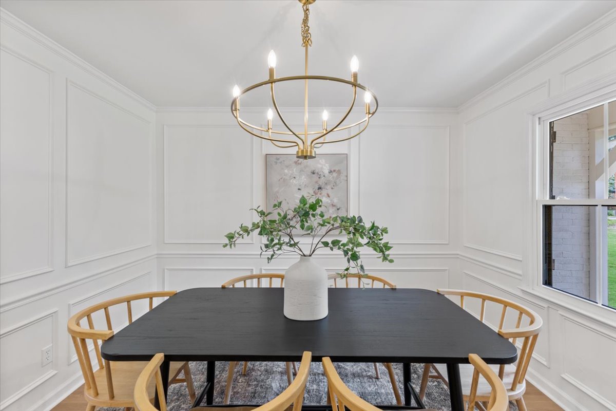 Pepperton: dining room with wall molding and chandelier