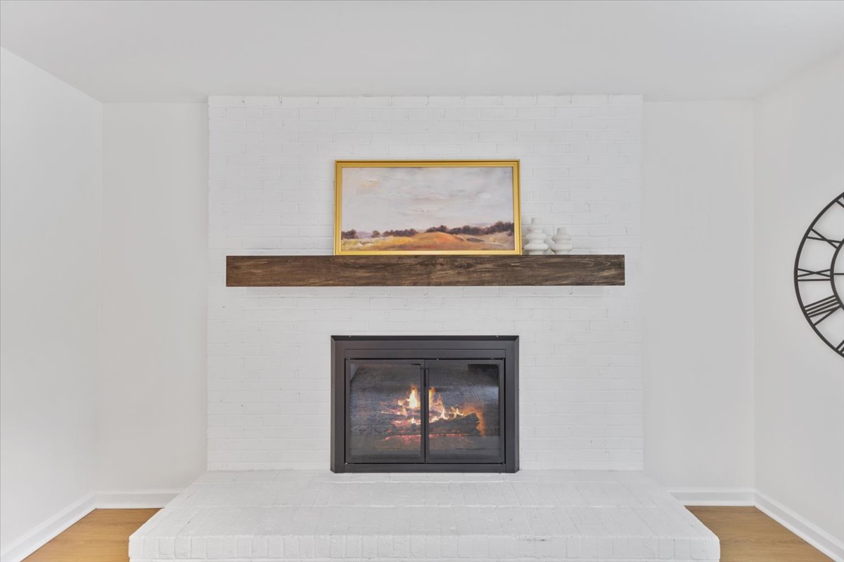 Pepperton: white brick fireplace and wood mantel