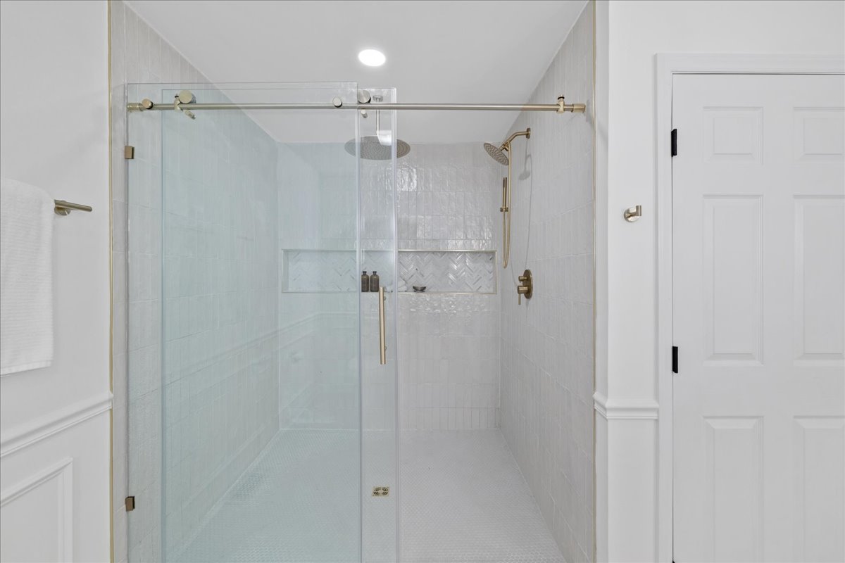 Pepperton: glass shower enclosure and brass fixtures