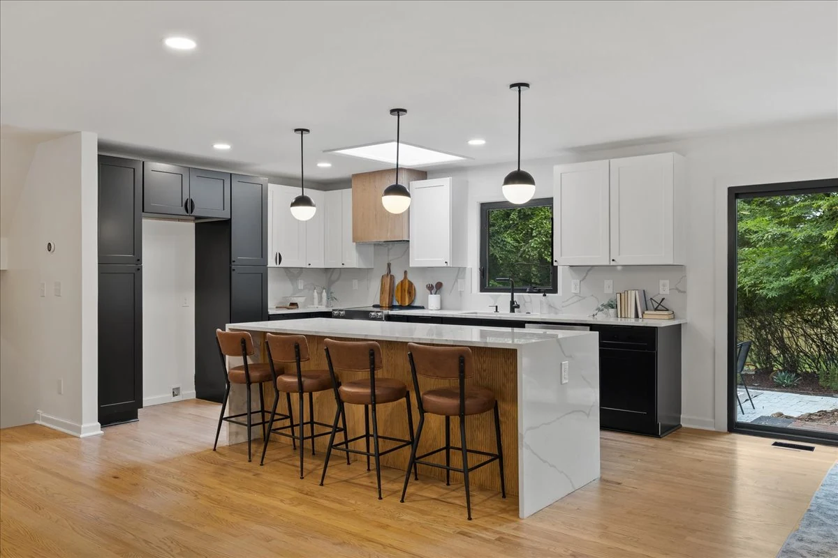 Ridgecrest kitchen with contrasting cabinets, a white island, and globe pendant lights