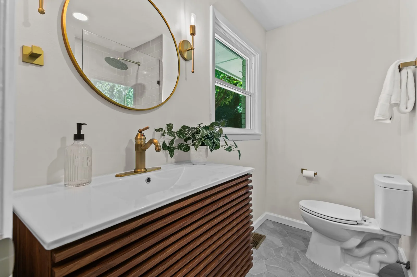 Roxanne: floating wood vanity and brass fixtures