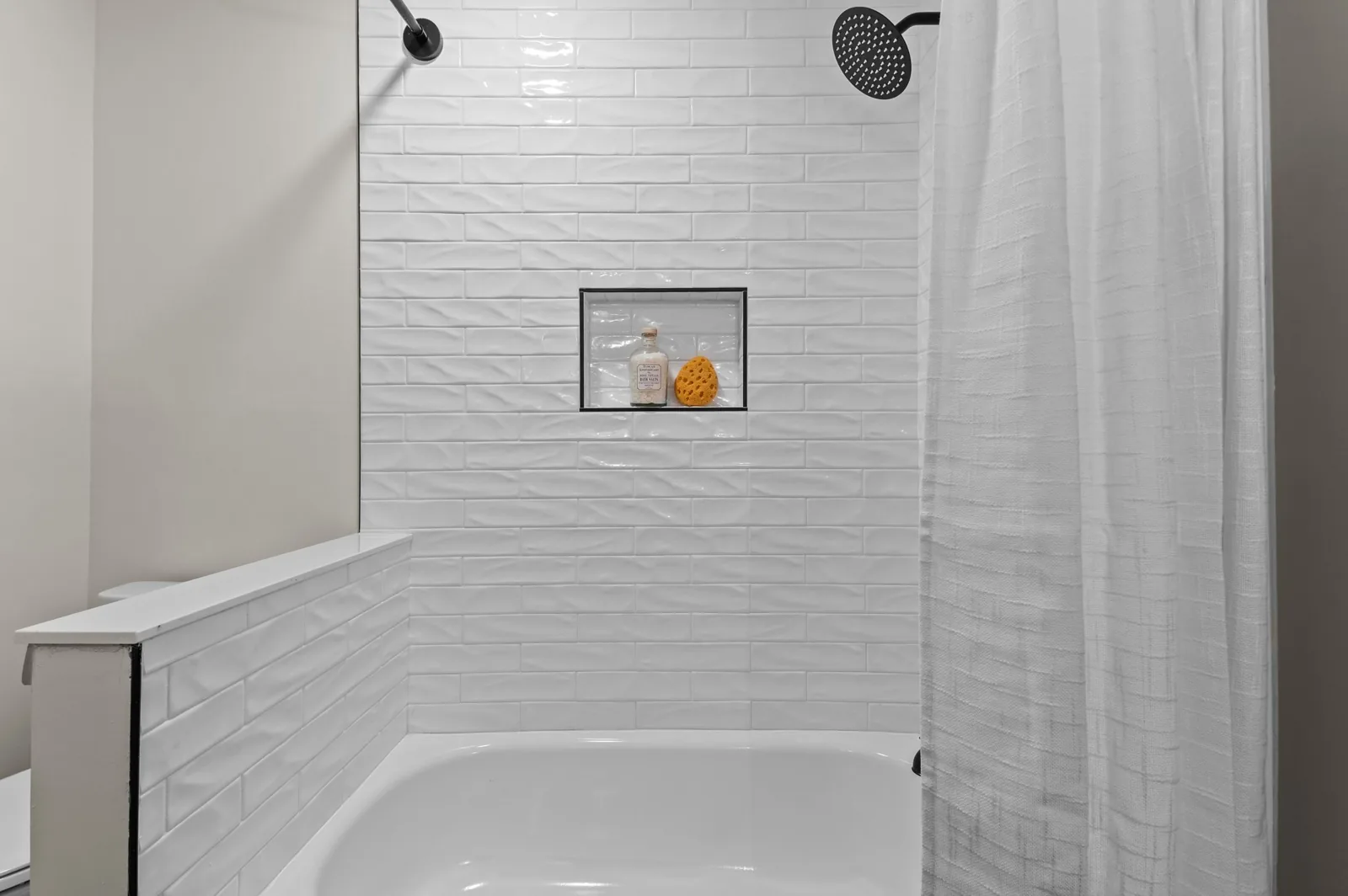 Roxanne: white tiled tub surround and shower niche