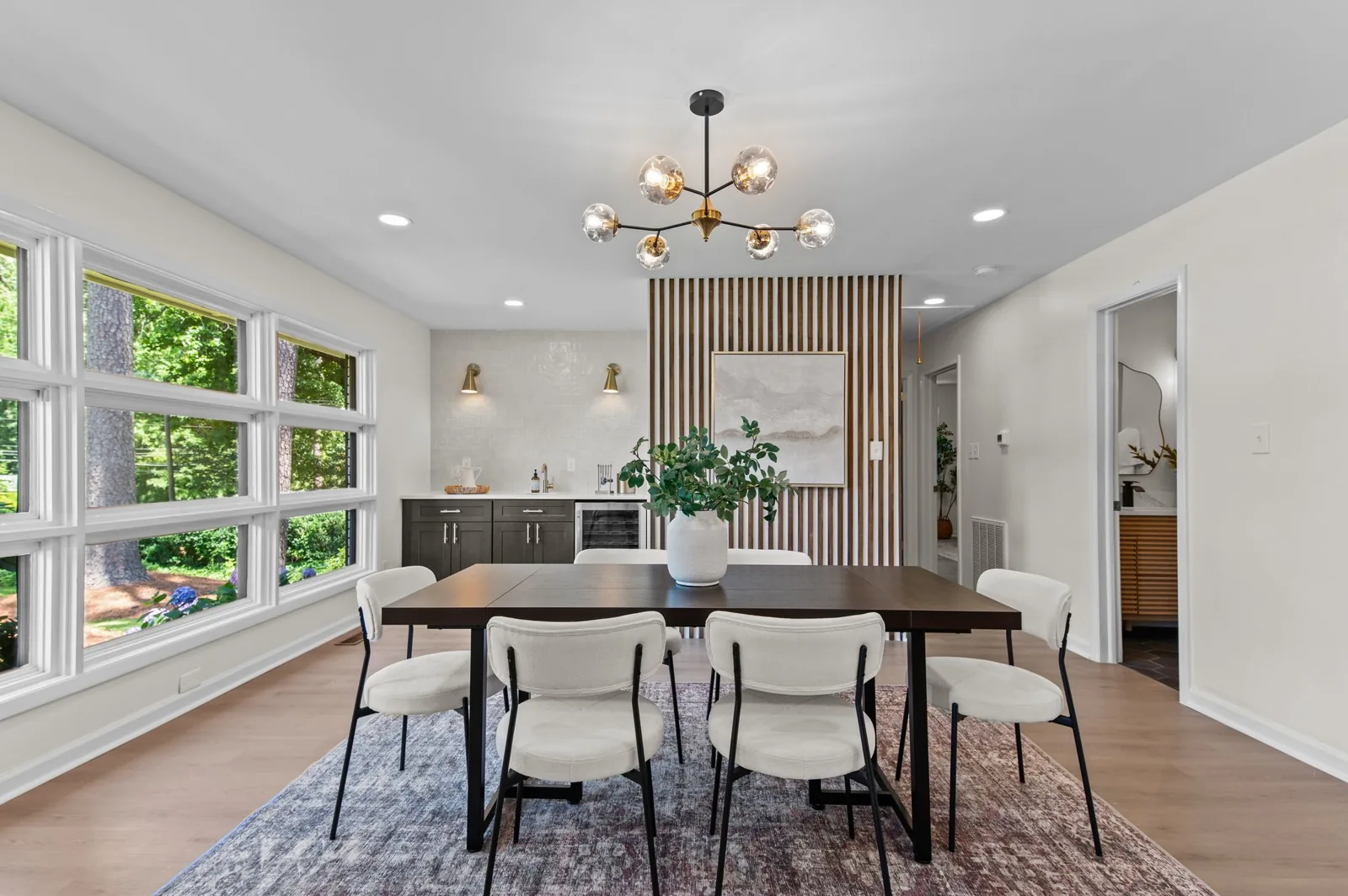 Roxanne: dining area with a wood-slat accent wall