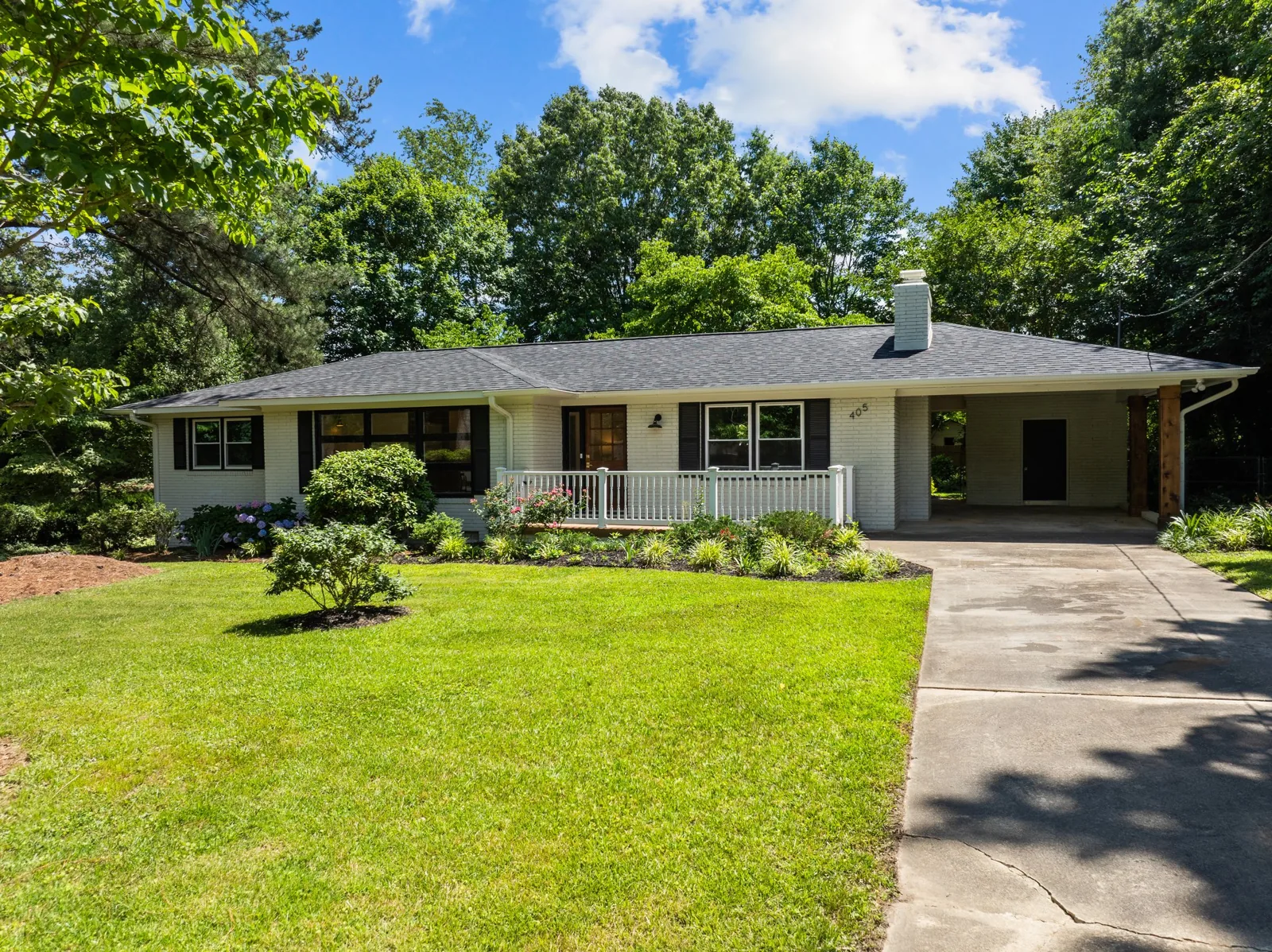 Roxanne: white brick exterior and front landscaping